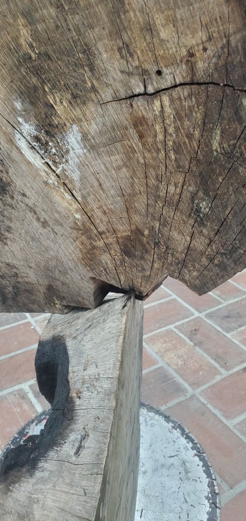 Wood pieces balanced on each other along incongruent edges.