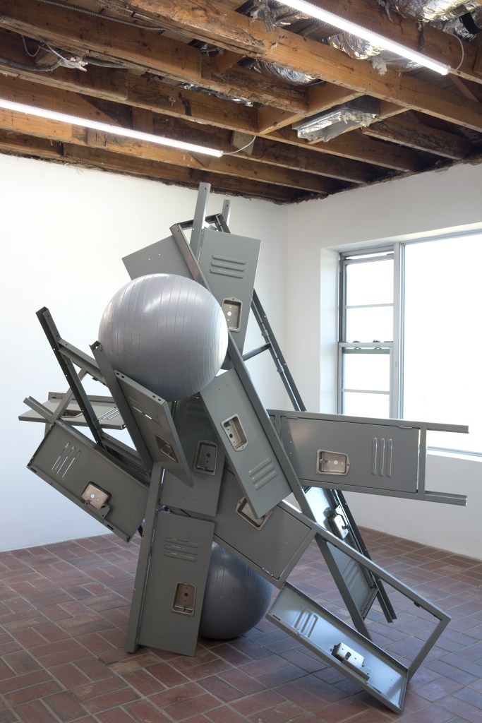 Grey lockers and yoga balls interlocked and stacked on each other.