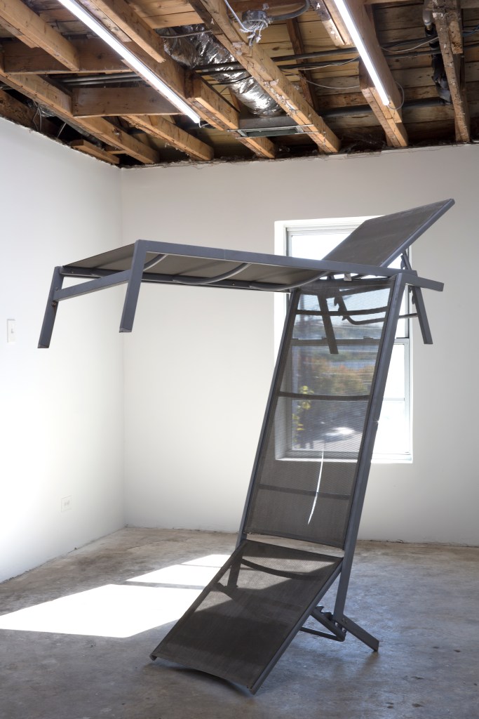 Lawn chairs balanced one on top of the other.